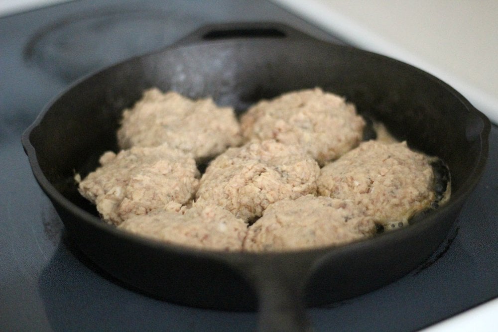 frying salmon burgers in a cast iron skillet