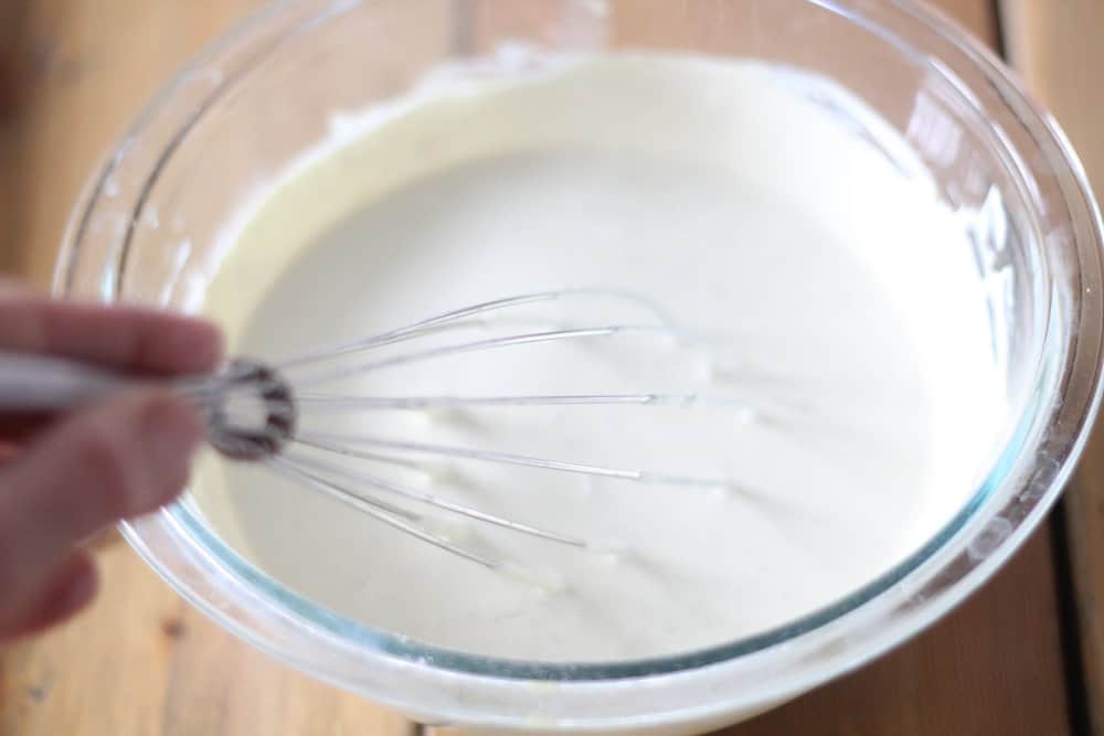 whisking in zinc oxide in a glass bowl