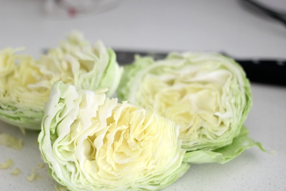 cabbage chopped on a white countertop to make homemade sauerkraut 