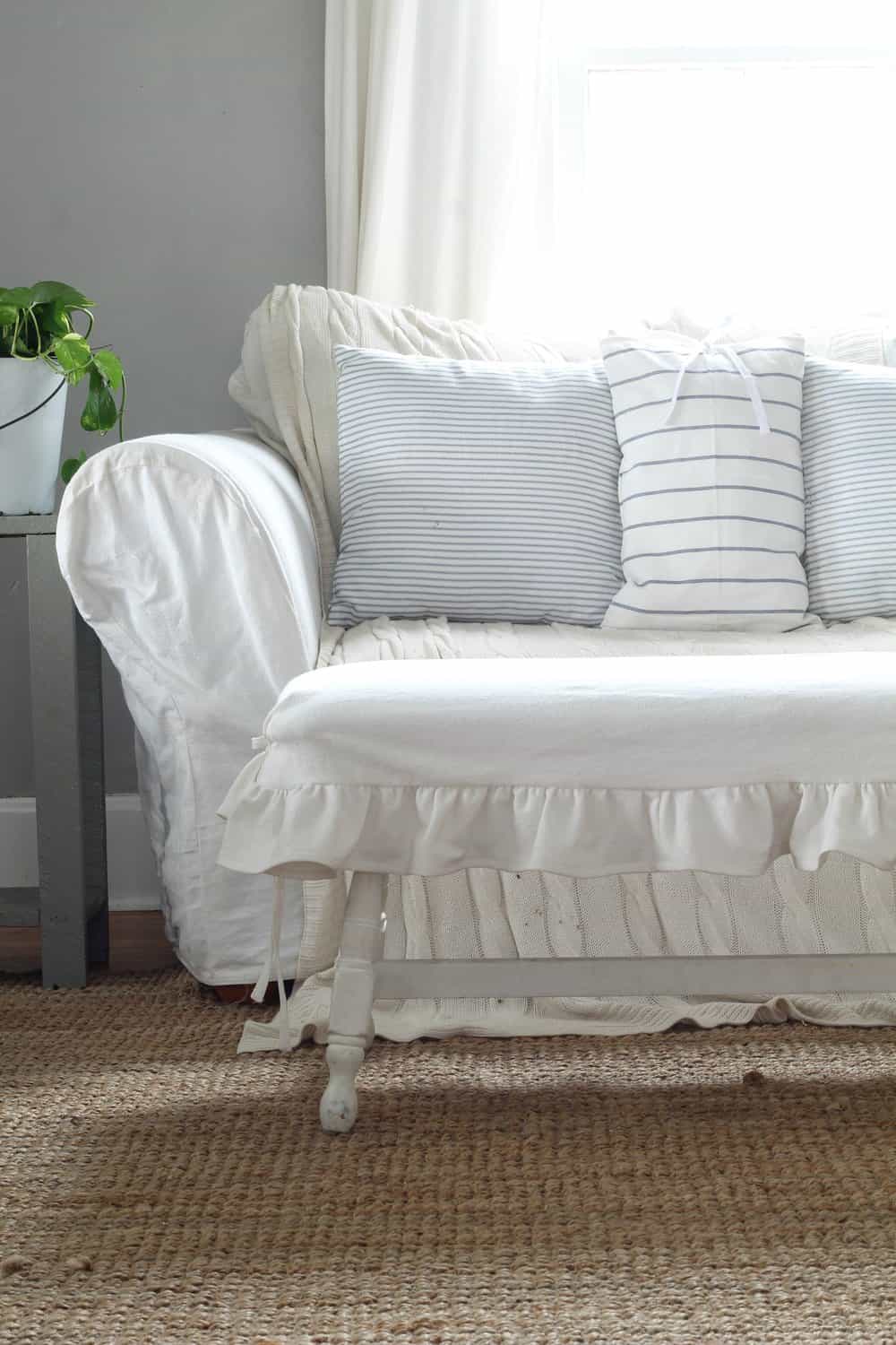 wooden bench with a DIY white drop cloth ruffle slipcover
