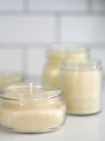 four beeswax candles on a white countertop