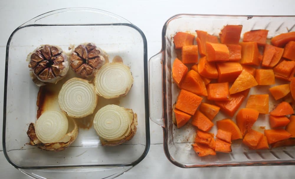 roasted garlic, onions, and chopped butternut squash i glass baking dishes right out of the oven for butternut squash soup