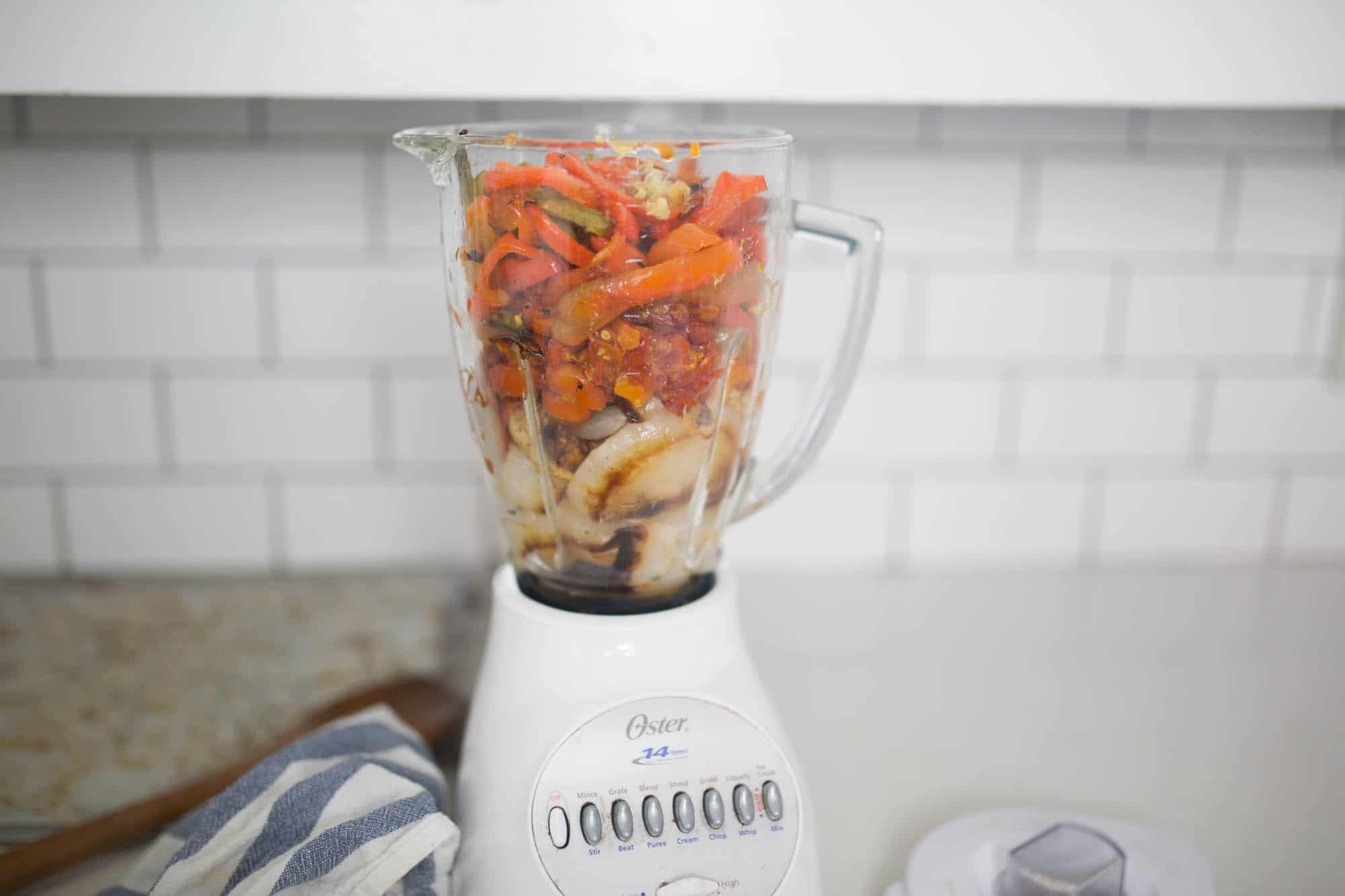 roasted veggies in a blender to make roasted red pepper and tomato soup