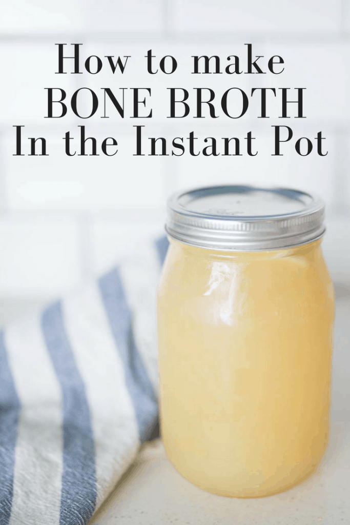 homemade bone broth in a mason jar on a kitchen counter with a blue and white stripped towel to the left