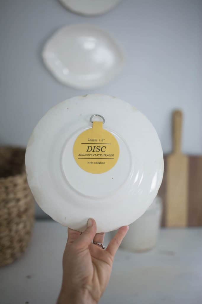 adhesive disk on the back of a stoneware plate - how to hang plates on a wall
