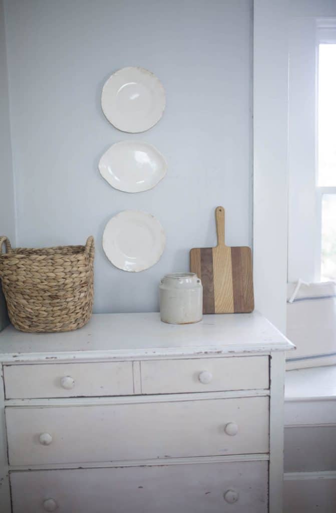 white stoneware plates hanging on a wall - how to hang plates on a wall tutorial