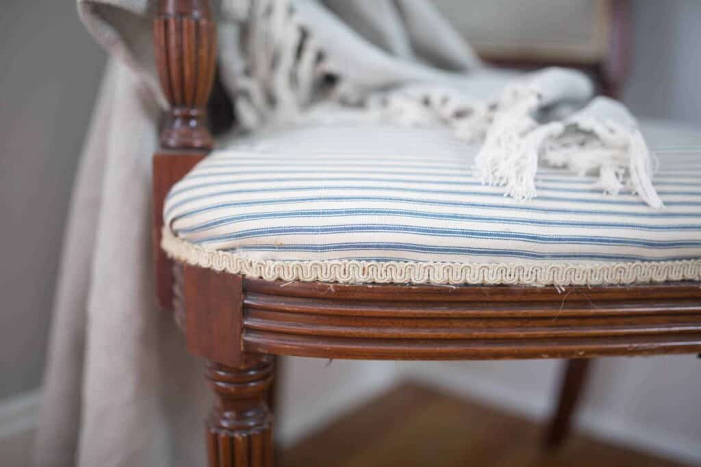 wood reupholster chair with ticking stripe fabric and antique trim