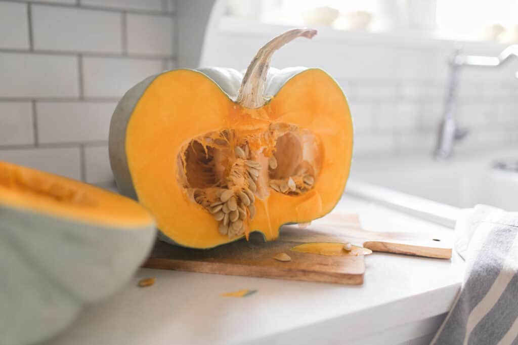 jarrahdale pumpkin on a countertop sliced in half - how to cook a pumpkin