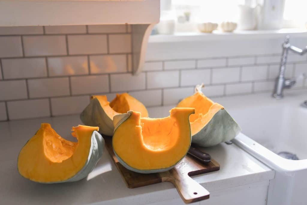 jarrahdale pumpkin sliced up on the counter - how to cook a pumpkin in the instant pot, oven, crock pot