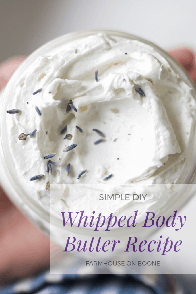 fluffy whipped body butter recipe in a glass jar and topped with lavender petals