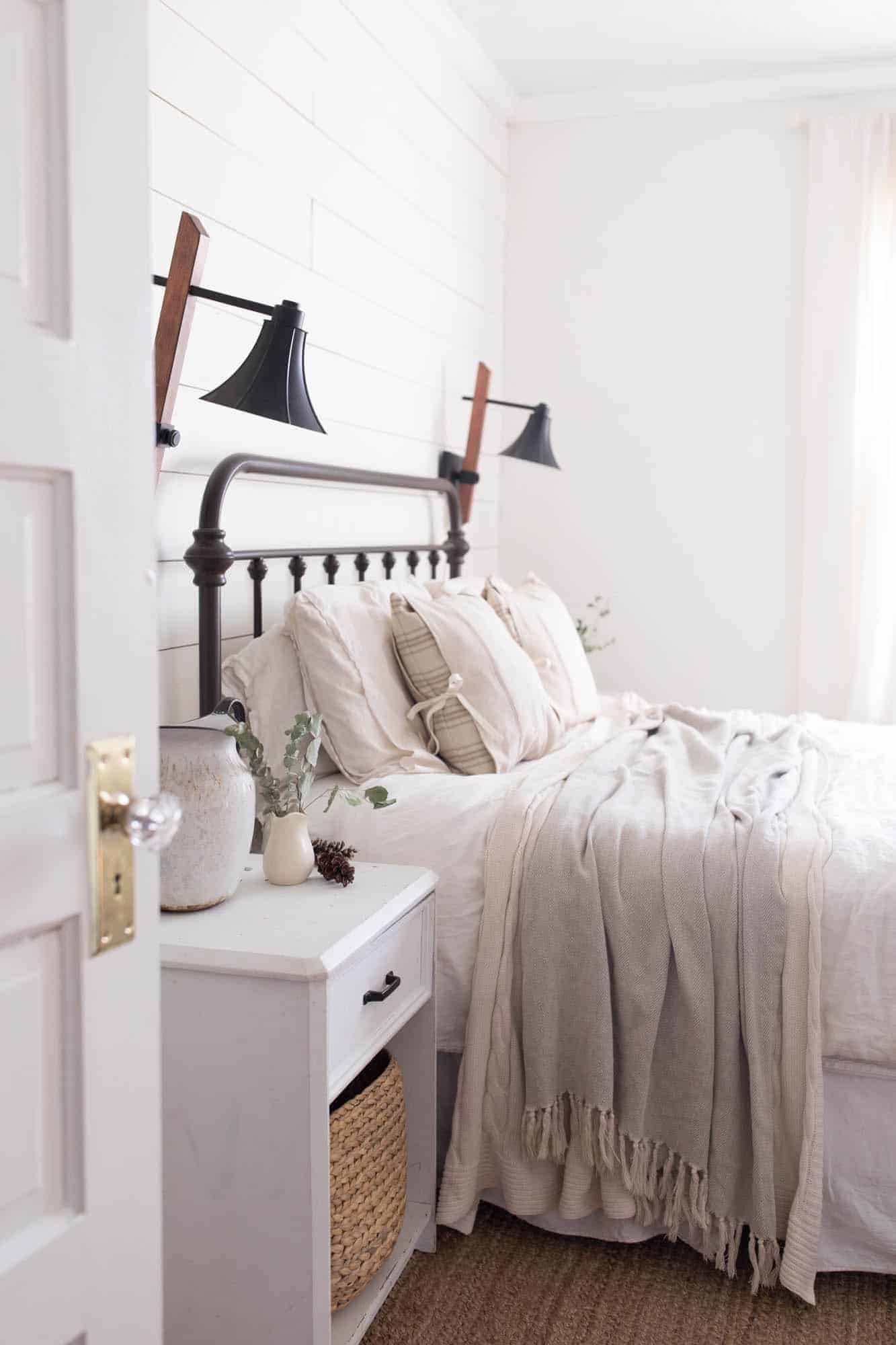 Tour our winter farmhouse bedroom with lots of natural elements like greenery and pine cones.