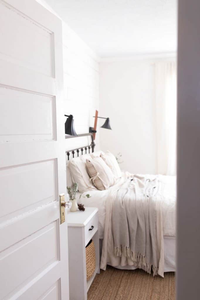 Tour our winter farmhouse bedroom with lots of natural elements like greenery and pine cones.