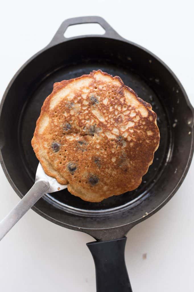 Sourdough Pancake Recipe with blueberries in a cast iron skillet