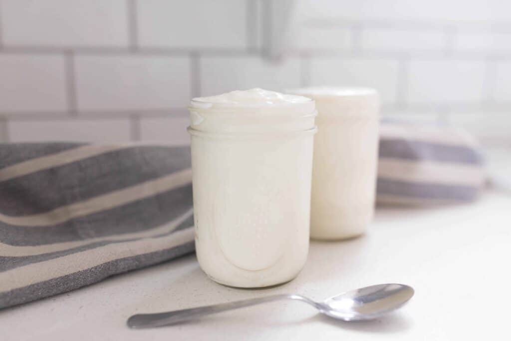two mason jars of instantpot yogurt on a counter