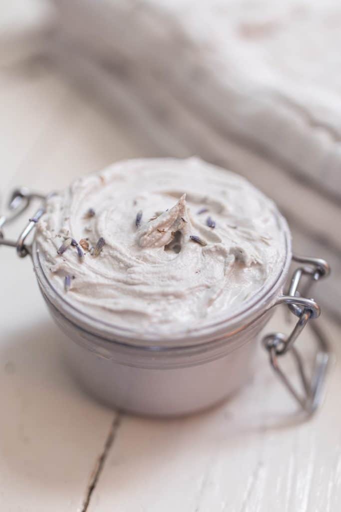 homemade diaper rash creaming a glass jar. Dried lavender is sprinkled on top