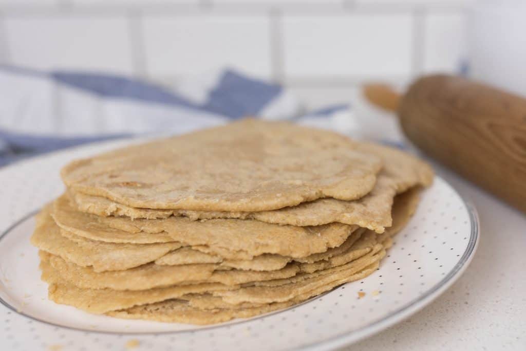 sourdough tortillas stacked on a white plate