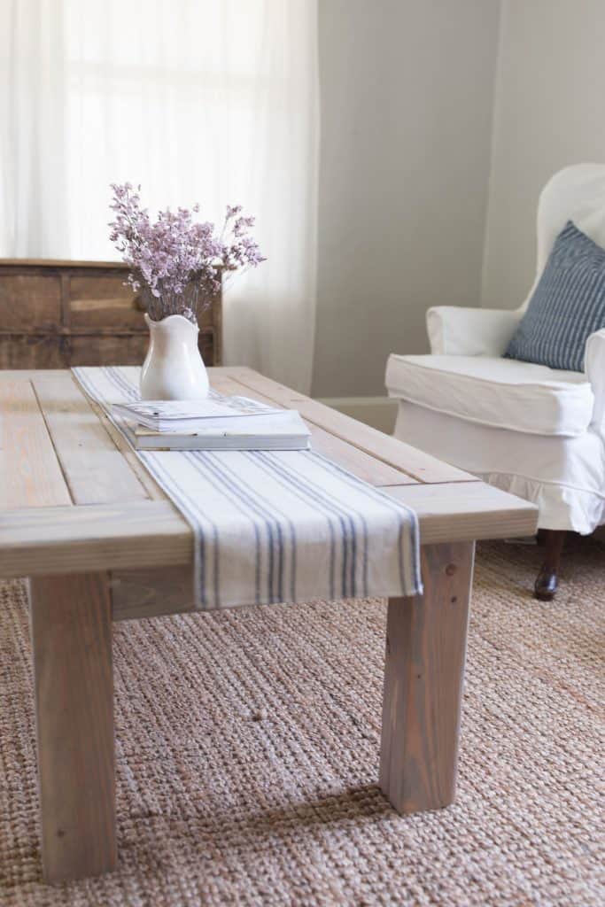 side angle of farmhouse coffee table build with table runner