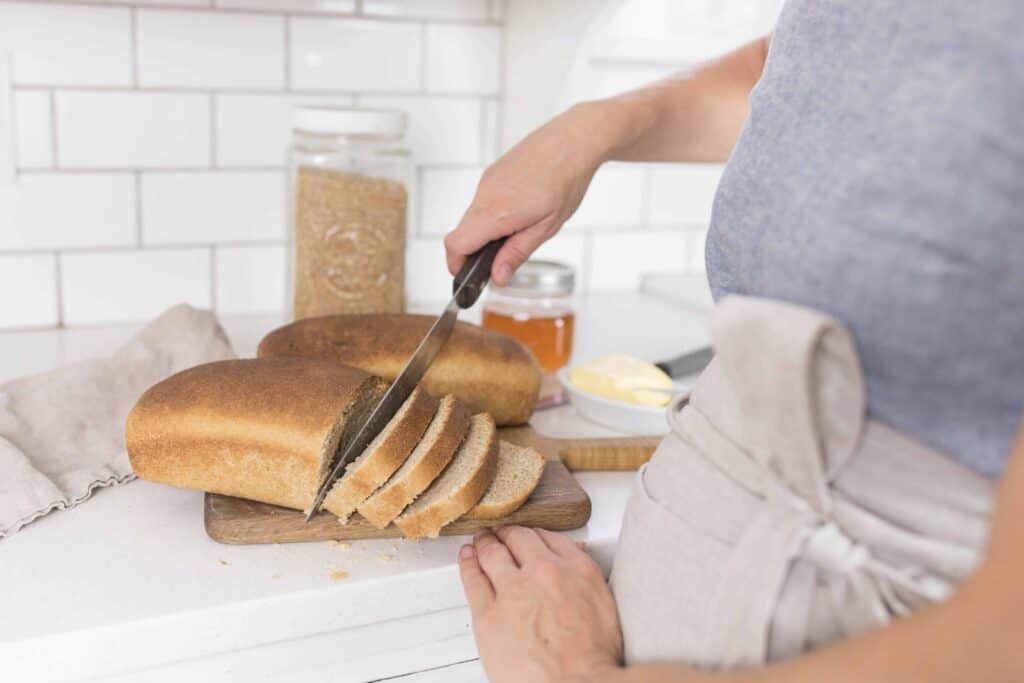 sourdough bread being sliced -wild fermentation wild yeast whole grain