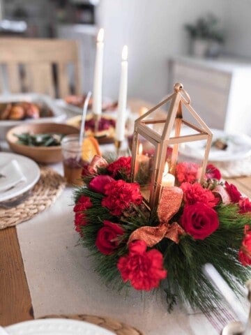 vibrant roses and rustic lantern Christmas centerpiece