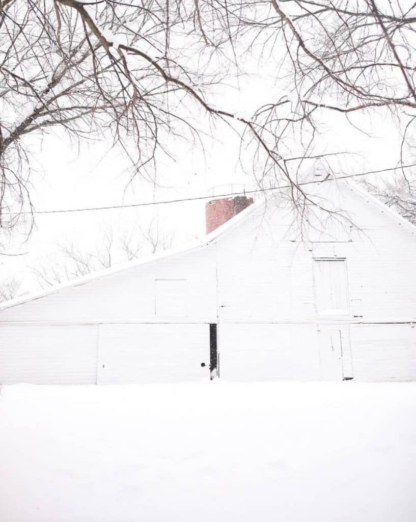 19th century white barn in the snow farmhouse on boone homestead