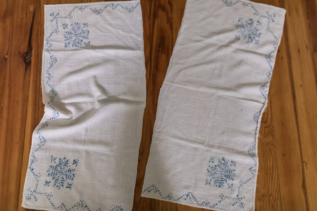 blue embroidered vintage table cloth cut in half to make farmhouse pillow covers 