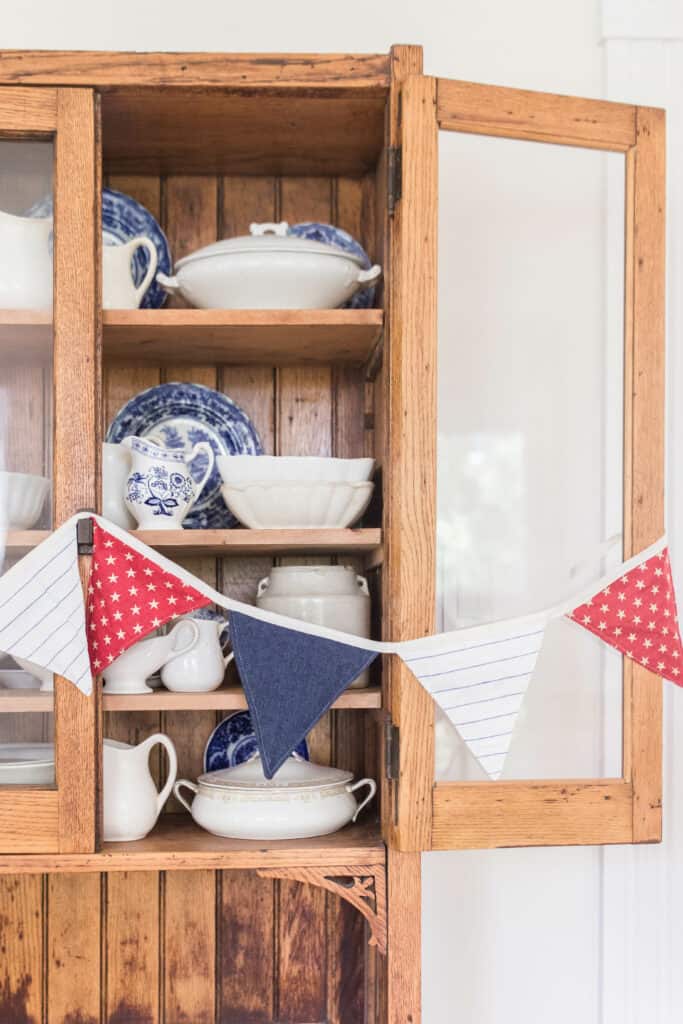 close up fourth of july bunting on vintage hutch