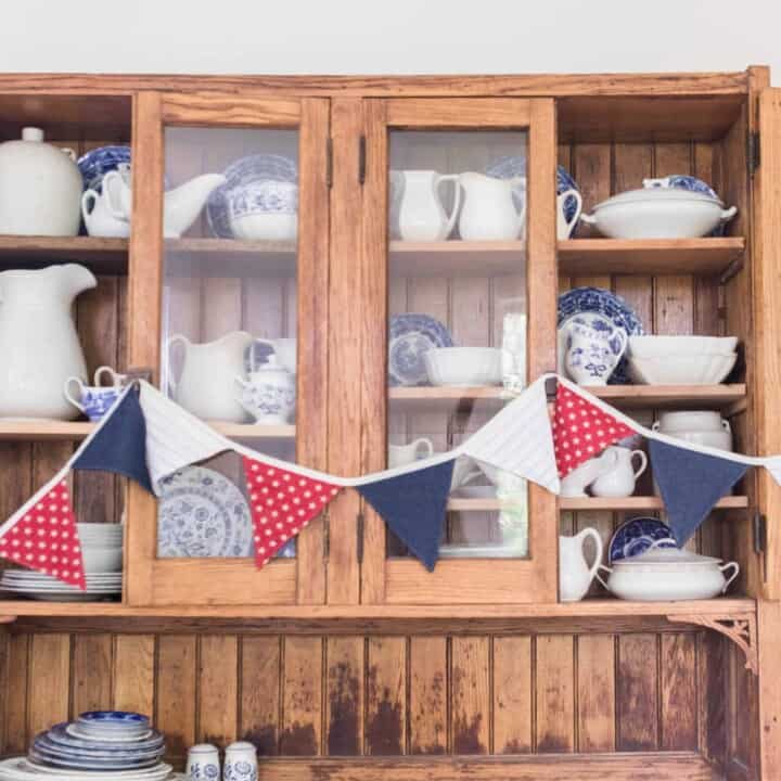red white and blue bunting on hutch with china
