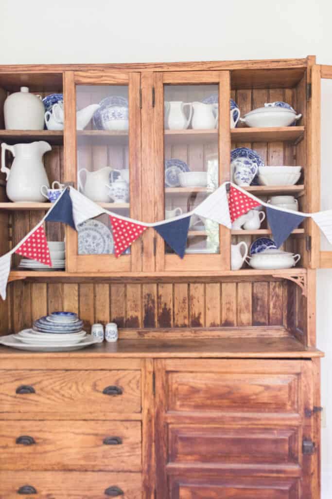 fabric bunting on antique hutch 