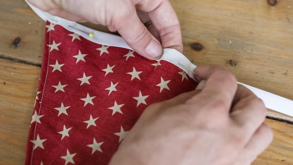 pinning fabric triangles into fabric bunting