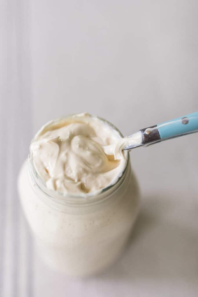 raw milk sour cream on a spoon in a mason jar