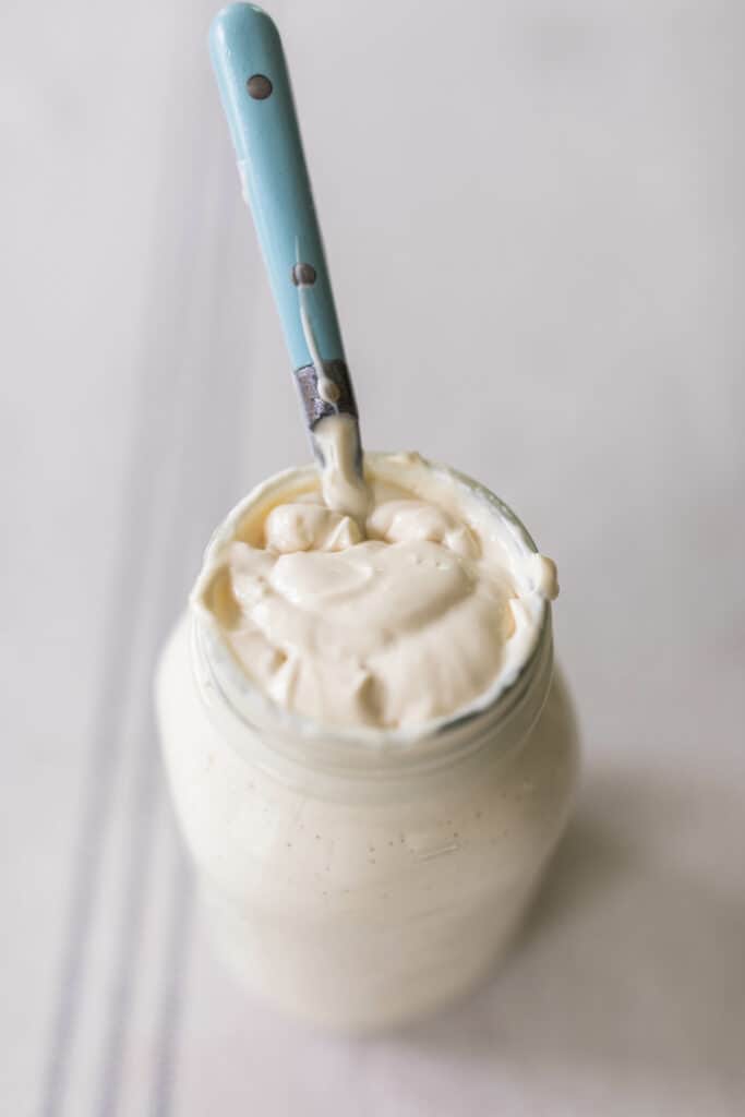 sour cream in mason jar with blue spoon