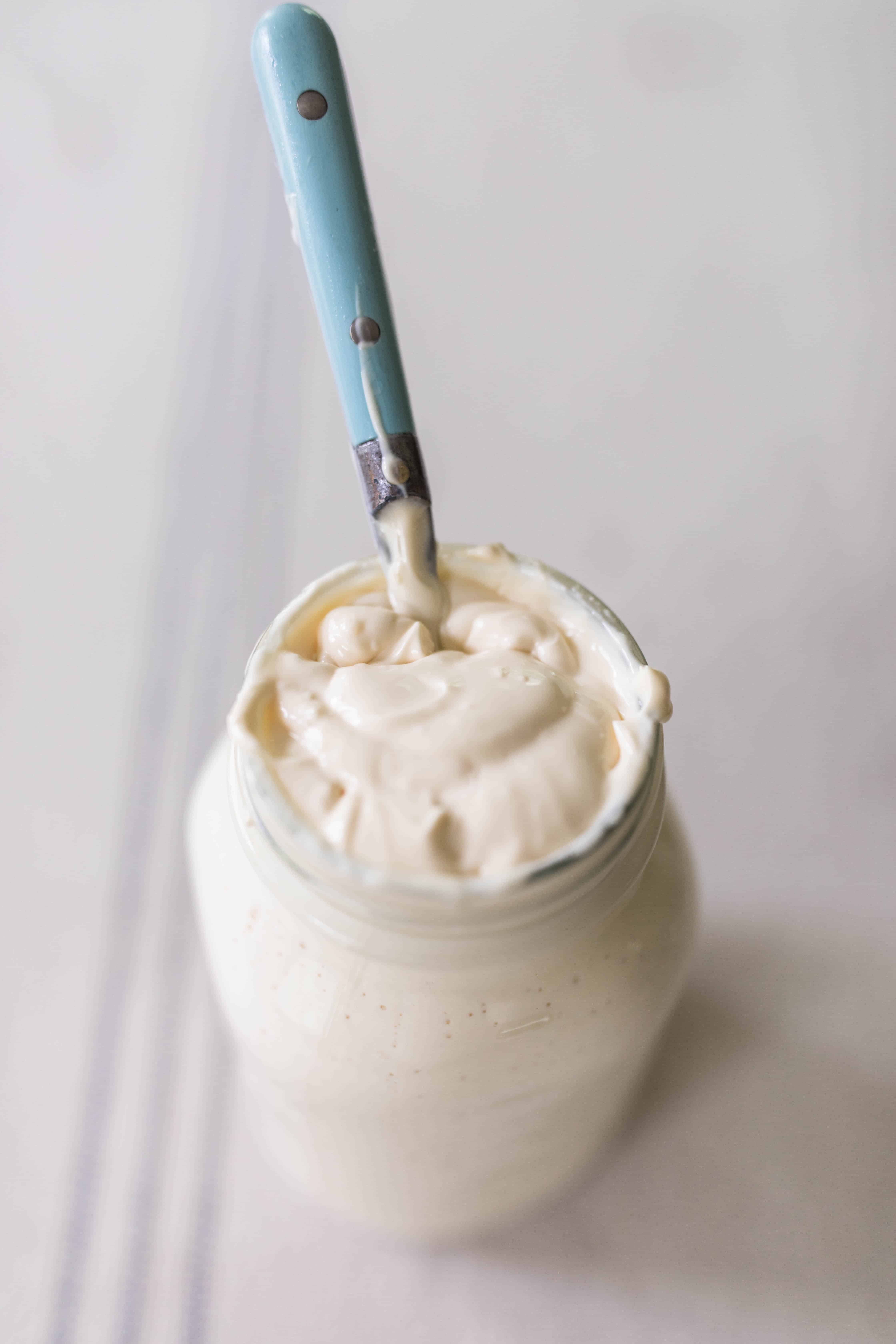 sour cream in mason jar with blue spoon