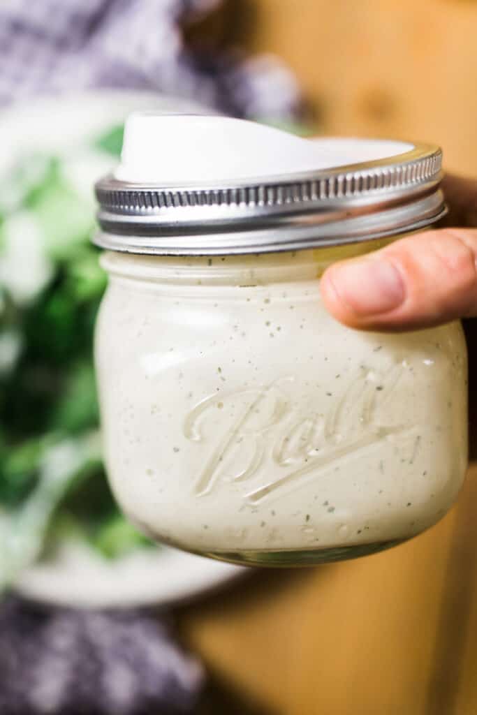 homemade ranch dressing in a mason jar with a pour lid 