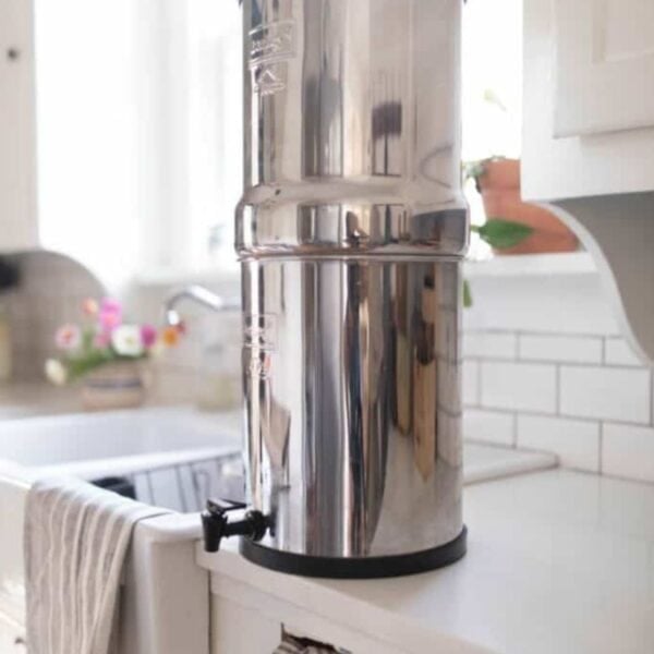 A stainless steel water filter on a counter top.