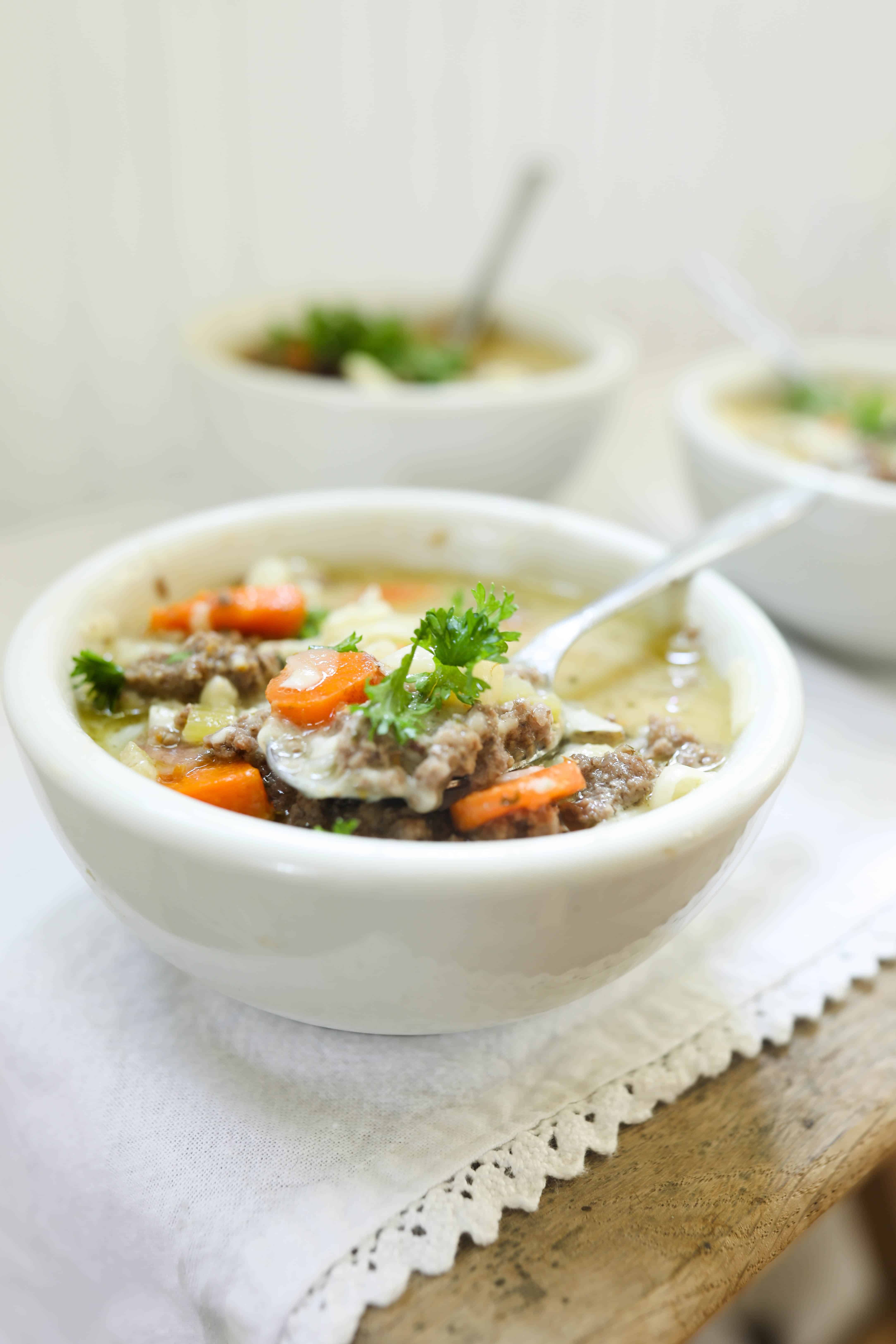 A soup pot with potatoes, carrots, and chicken broth. 