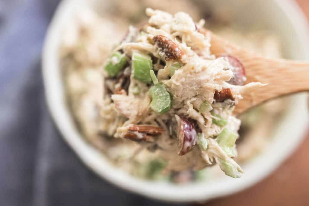 scooping out a helping of classic chicken salad with grapes