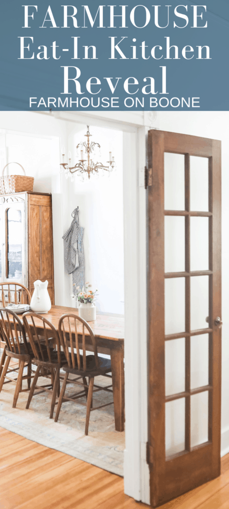 a open wood french door looking into the farmhouse eat-in kitchen with a wood table and chairs and antique hutch