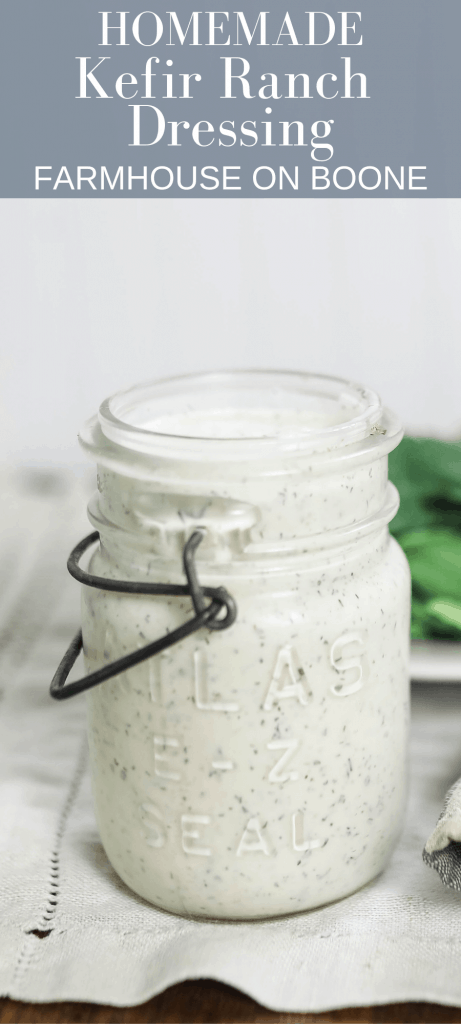 kefir ranch dressing in a vintage mason jar with metal lid holder with greens behind it