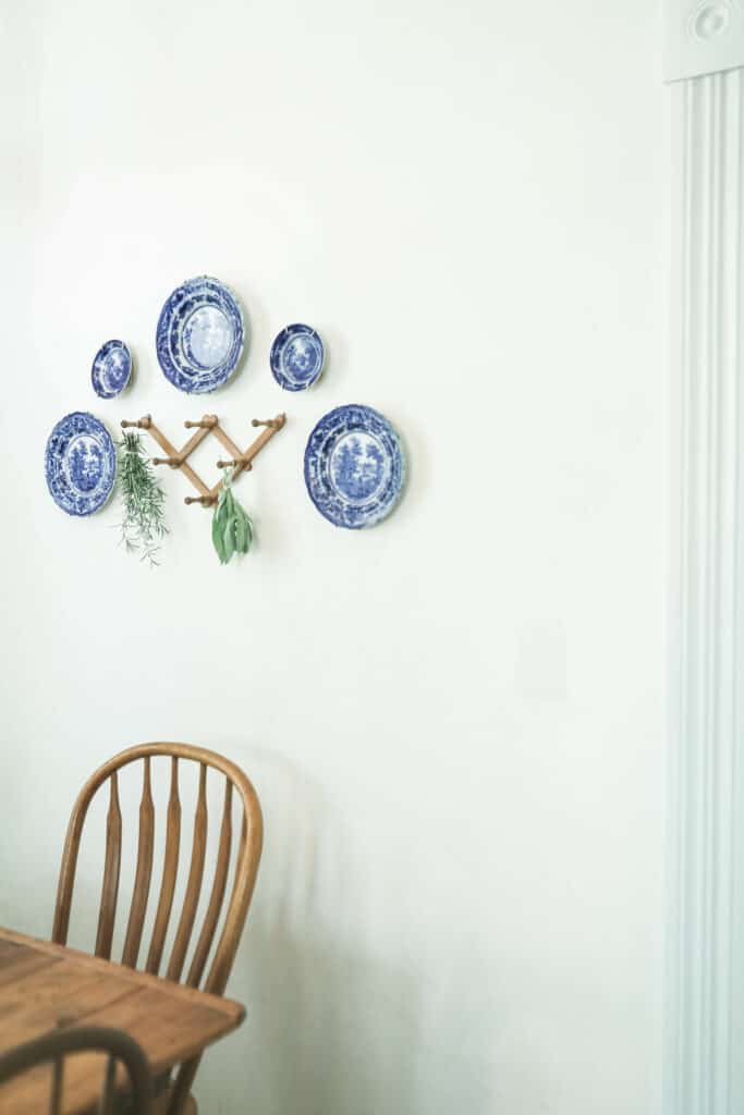 blue and white places hung on a wall with peg shelf