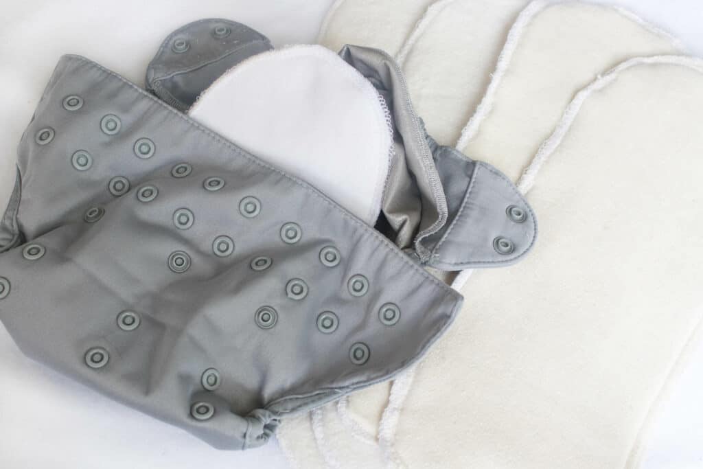 gray cloth diaper cover with DIY cloth diaper inserts to the right