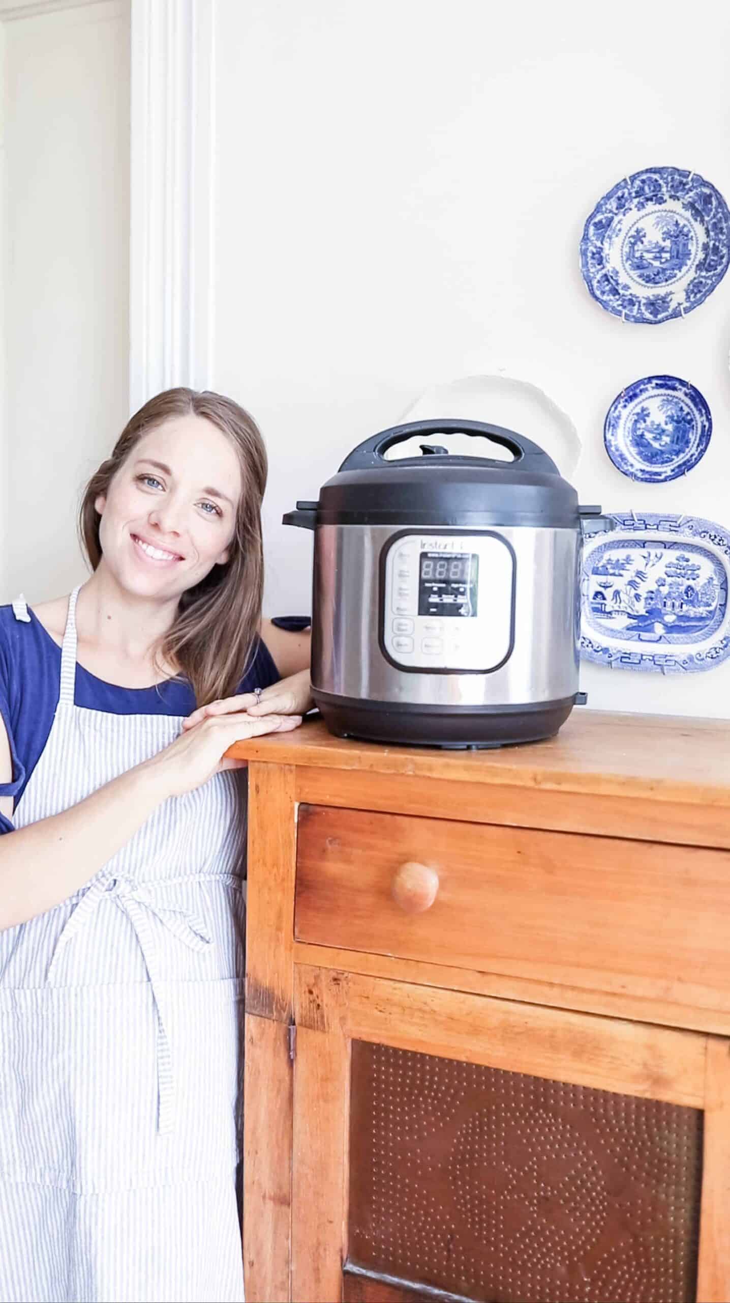 women standing next to large wood cabinet with a Instant Pot on top