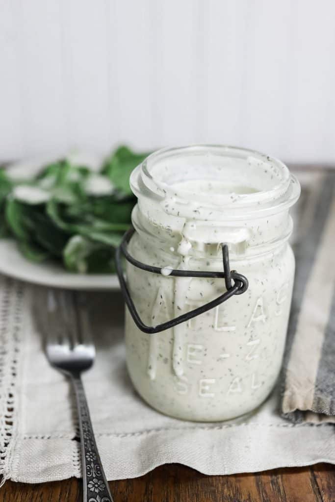 close up picture of kefir ranch dressing next to salad