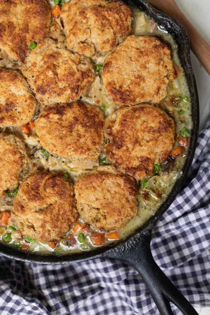 overhead shot of a cast iron skillet with the best chicken pot pie with biscuit crust