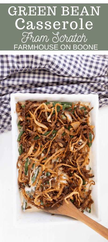 homemade green bean casserole topped with fried onions in a white baking dish on a white countertop