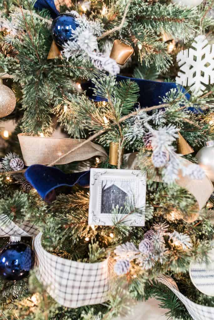 handmade Christmas ornaments hanging on a blue and white decorated tree