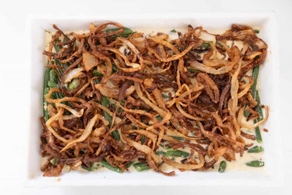 classic green bean casserole from scratch in a white baking dish