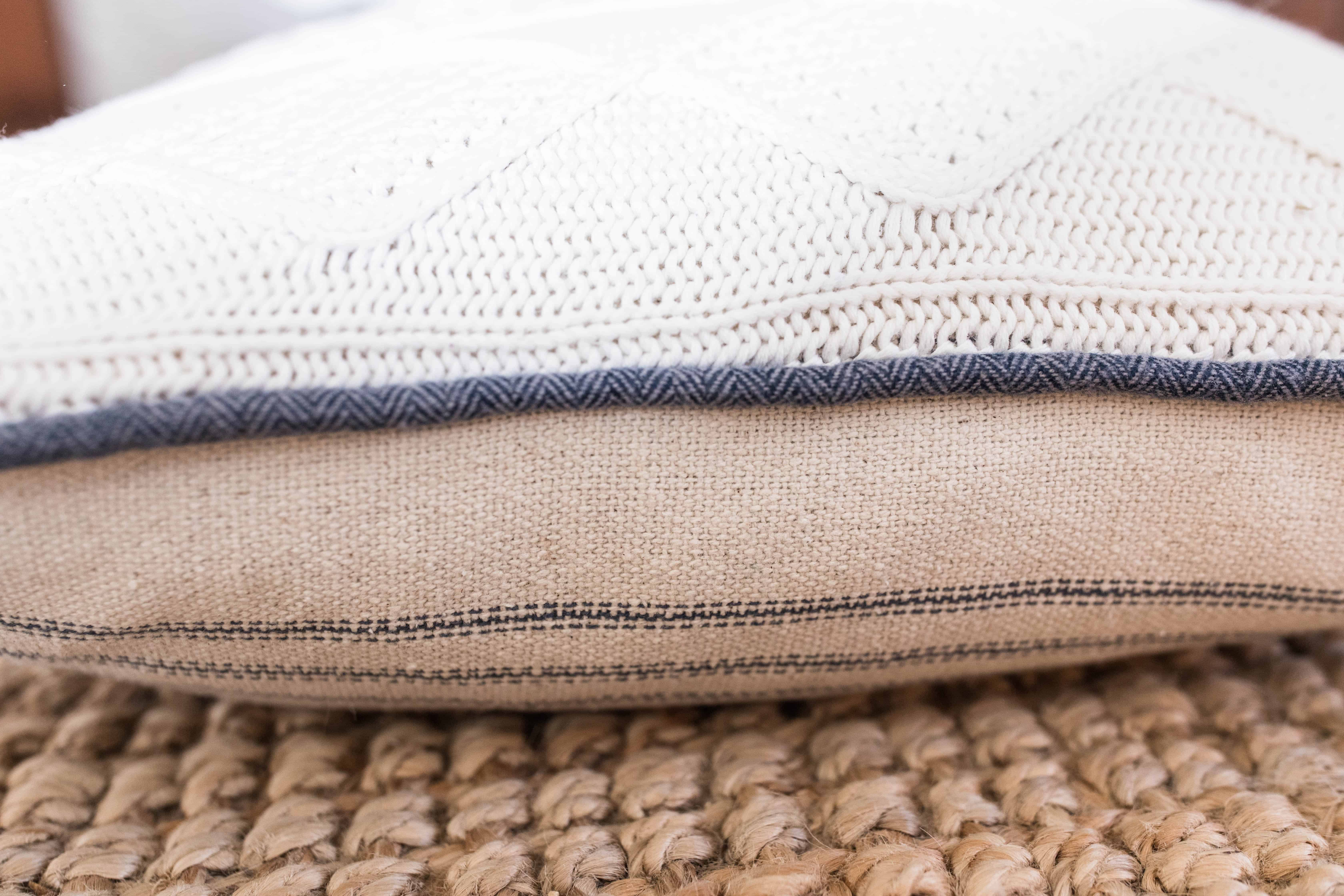 side view of sweater pillow with a thrifted sweater on one side and duck fabric on the other