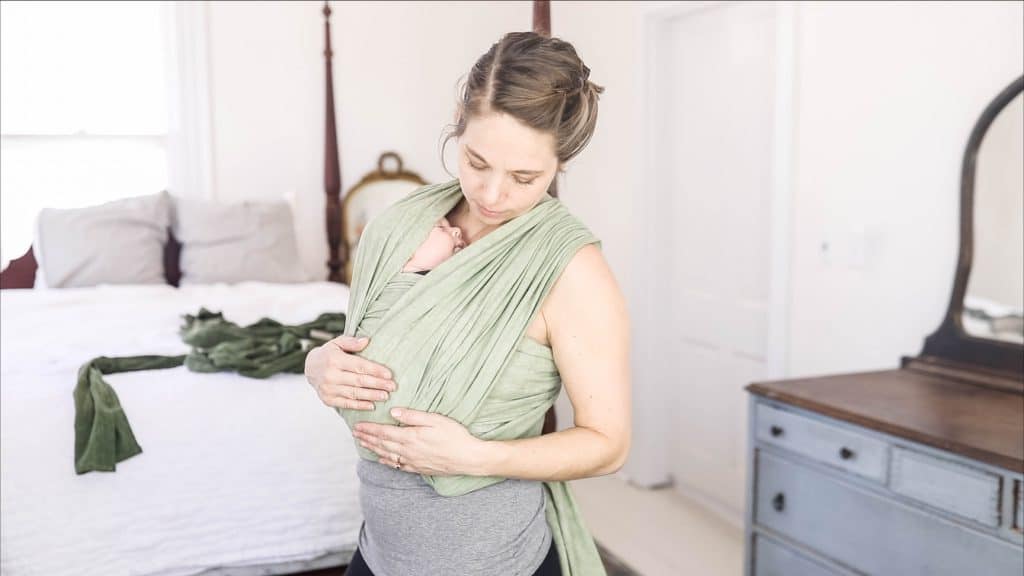 women baby wearing using a green woven wrap