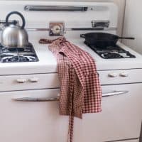 diy reversible apron on a white antique stove
