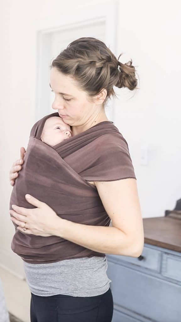 women baby wearing with a brown Moby wrap - best baby carriers